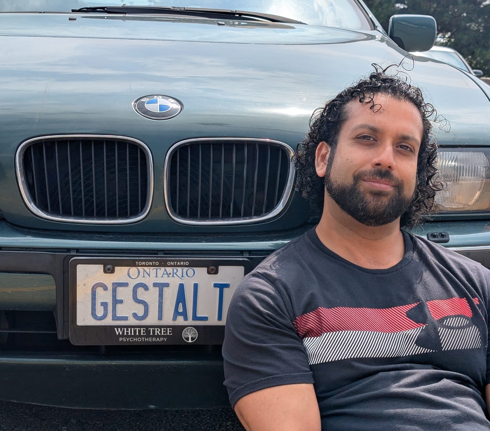 Jonathan Jutsun with his BMW, license plate reading GESTALT